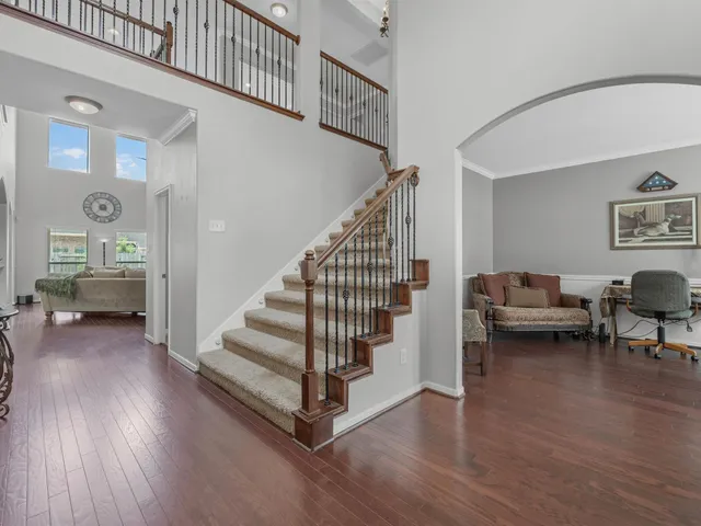 a view of entryway and hall with wooden floor