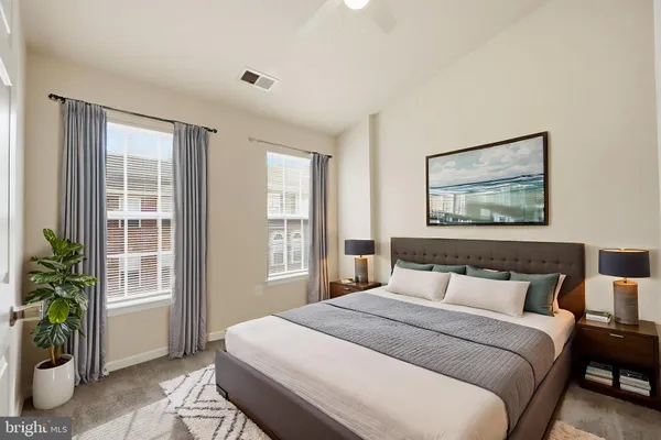 a bedroom with a large bed and a large window