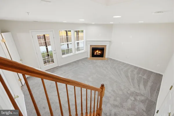 a view of an empty room with a fireplace