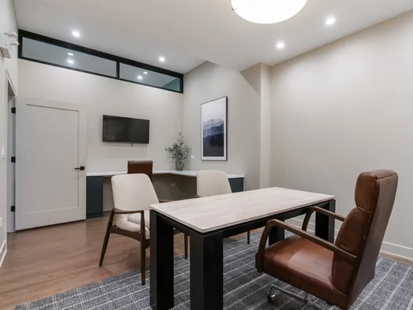 a view of a livingroom with furniture and a flat screen tv