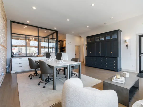 a view of a livingroom with workspace and a window