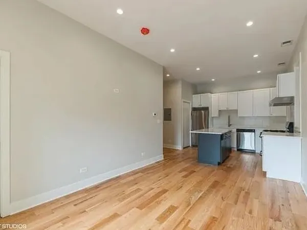 a view of kitchen with stainless steel appliances refrigerator microwave and stove