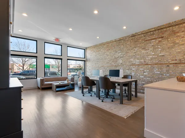 a dining room with furniture and a floor to ceiling window