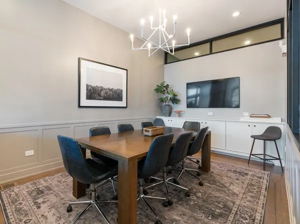 a view of a dining room with furniture and a chandelier