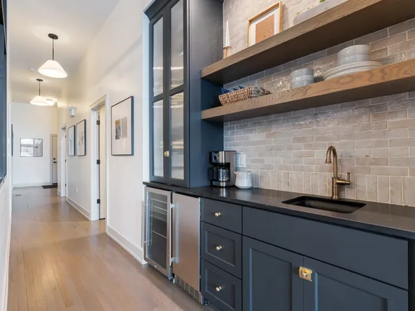 a kitchen with stainless steel appliances granite countertop a sink a stove and cabinets