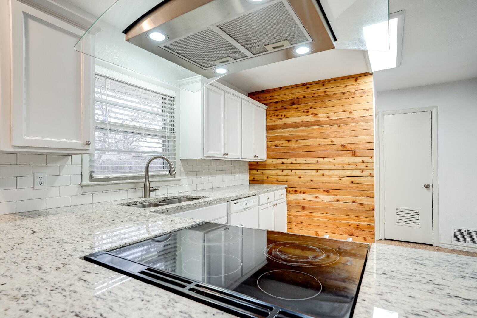 2826 54th Street Lubbock, TX 79413 - Photo 14 of 32 a kitchen with granite countertop a sink and a stove