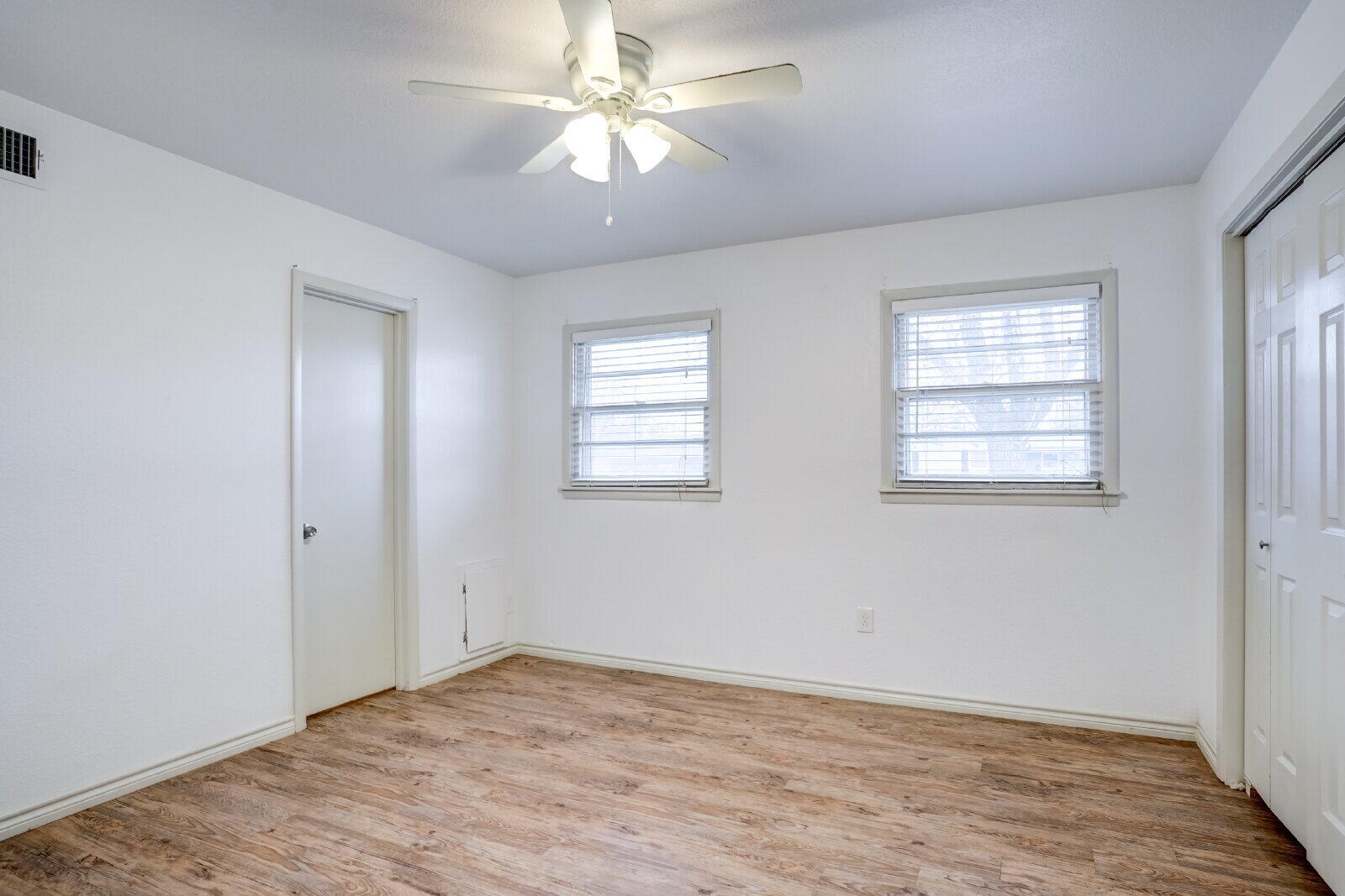 2826 54th Street Lubbock, TX 79413 - Photo 15 of 32 wooden floor in an empty room with a window