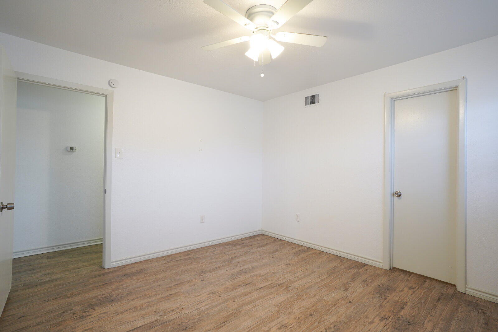 2826 54th Street Lubbock, TX 79413 - Photo 18 of 32 a view of an empty room with wooden floor