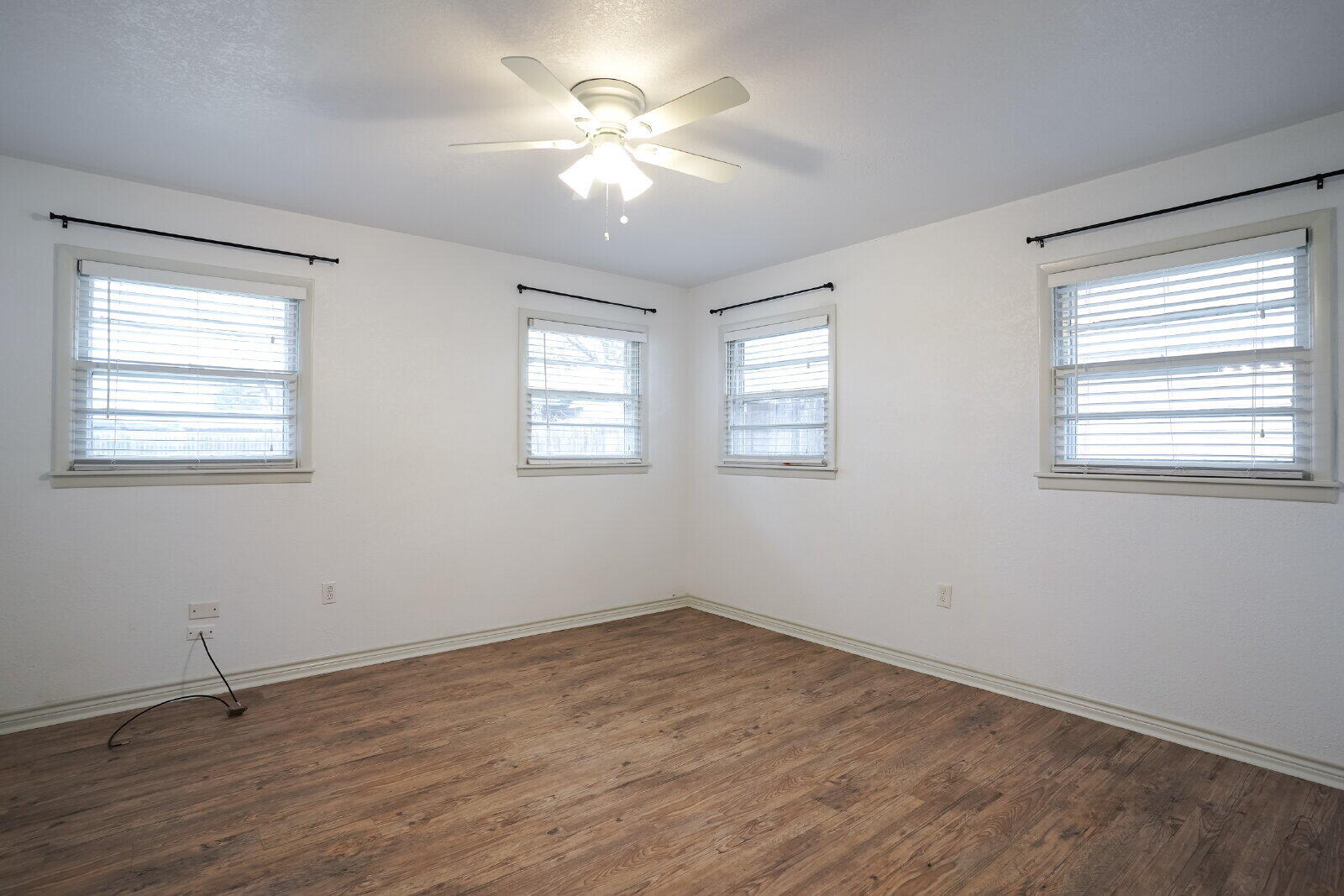 2826 54th Street Lubbock, TX 79413 - Photo 22 of 32 a view of empty room with wooden floor and fan