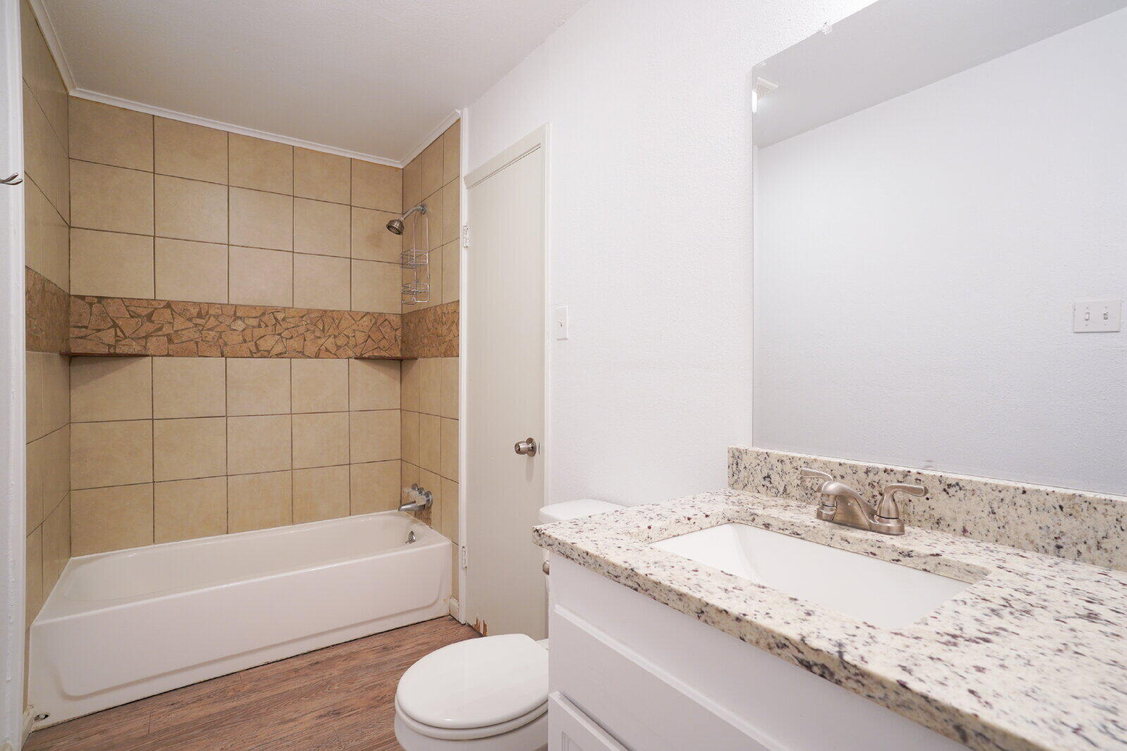 2826 54th Street Lubbock, TX 79413 - Photo 24 of 32 a bathroom with a granite countertop bathtub shower sink vanity and toilet