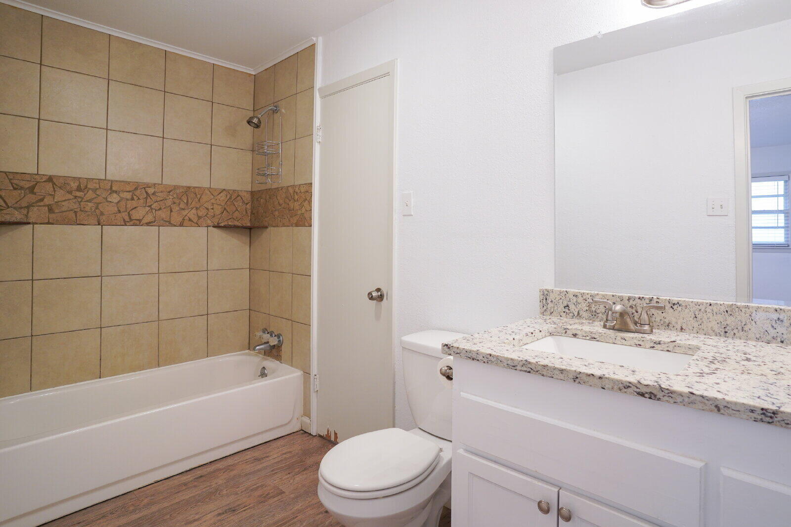 2826 54th Street Lubbock, TX 79413 - Photo 25 of 32 a bathroom with a sink a toilet and bathtub