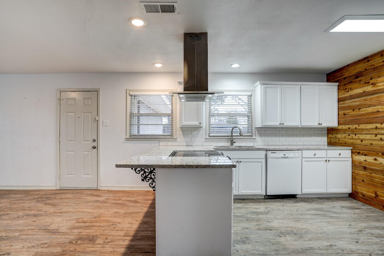 2826 54th Street Lubbock, TX 79413 - Photo 4 of 32 a kitchen with kitchen island granite countertop a sink stainless steel appliances and cabinets