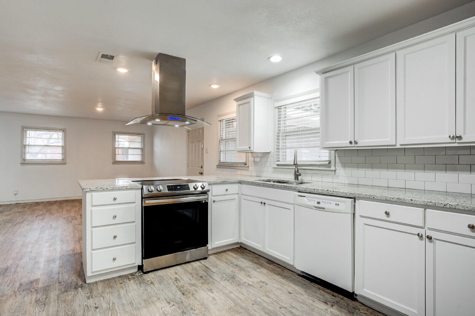 2826 54th Street Lubbock, TX 79413 - Photo 7 of 32 a kitchen with stainless steel appliances granite countertop a stove and a sink