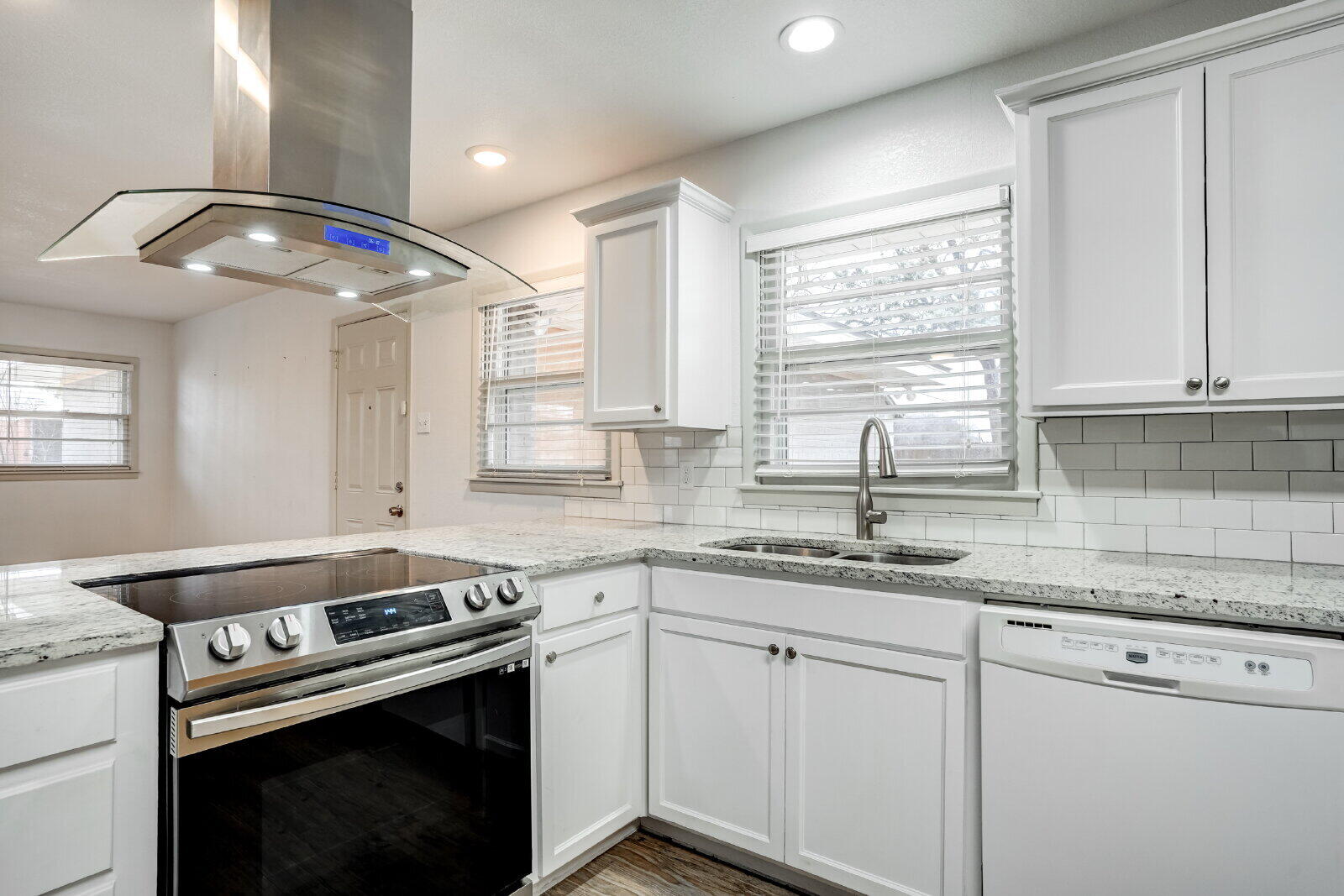 2826 54th Street Lubbock, TX 79413 - Photo 8 of 32 a kitchen with stainless steel appliances granite countertop a sink a stove and cabinets