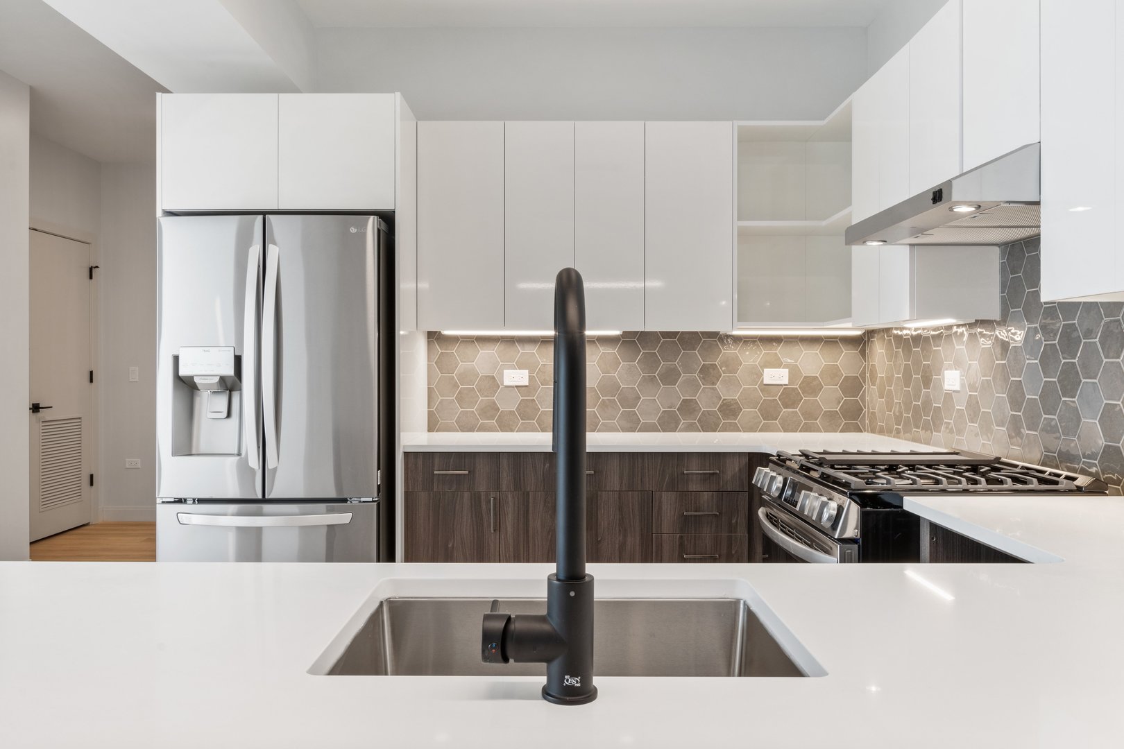 Undisclosed Address Chicago, IL 60640 - Photo 5 of 35 a kitchen with a sink a refrigerator and a stove top oven