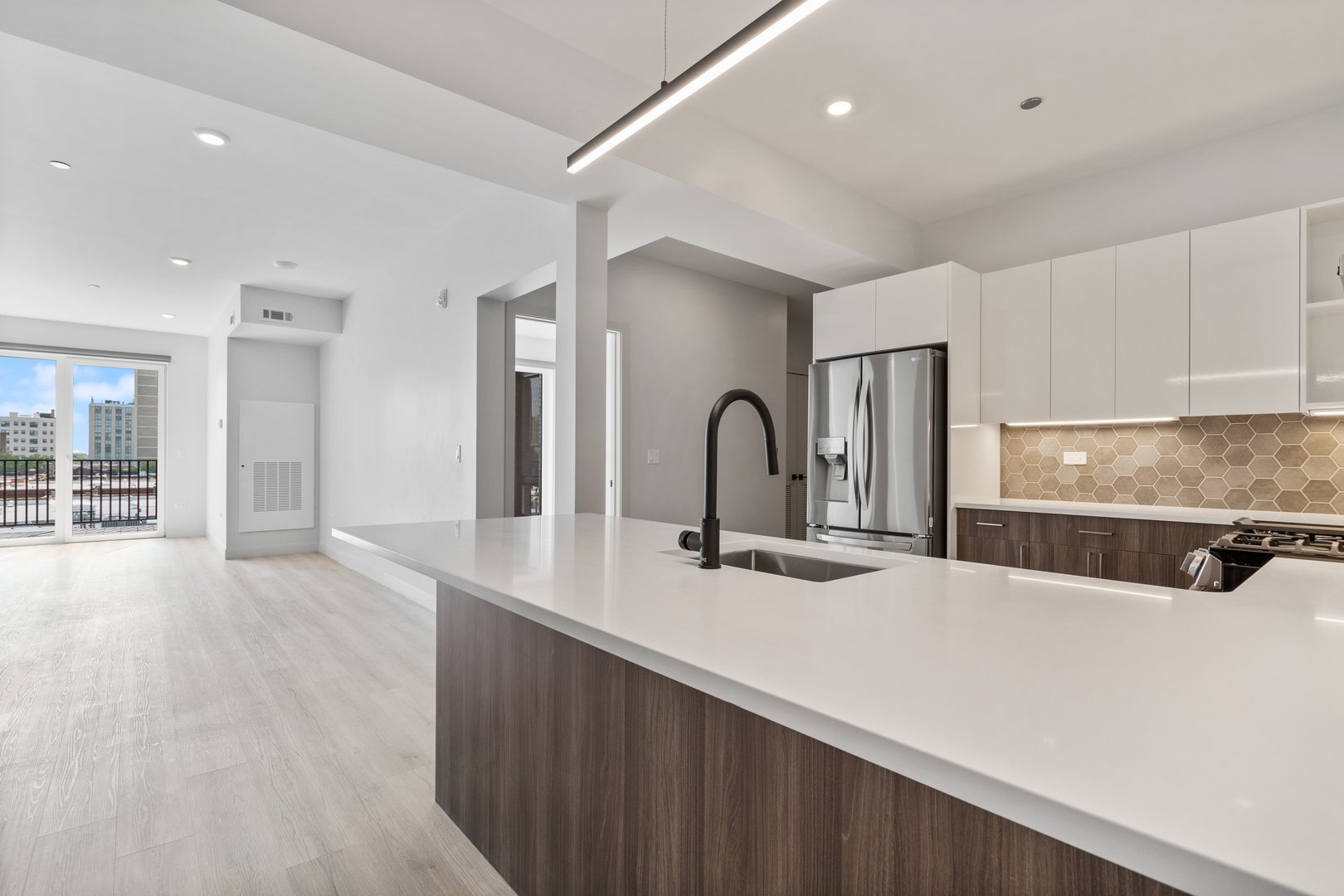 Undisclosed Address Chicago, IL 60640 - Photo 6 of 35 a kitchen with stainless steel appliances a sink and a refrigerator
