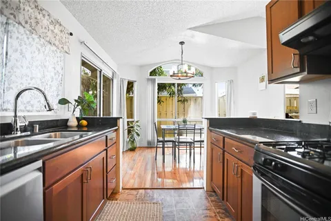 a kitchen with stainless steel appliances a sink stove and cabinets