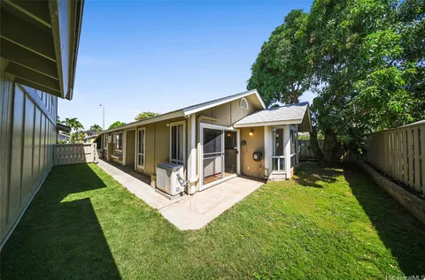 a view of a house with backyard porch and sitting area