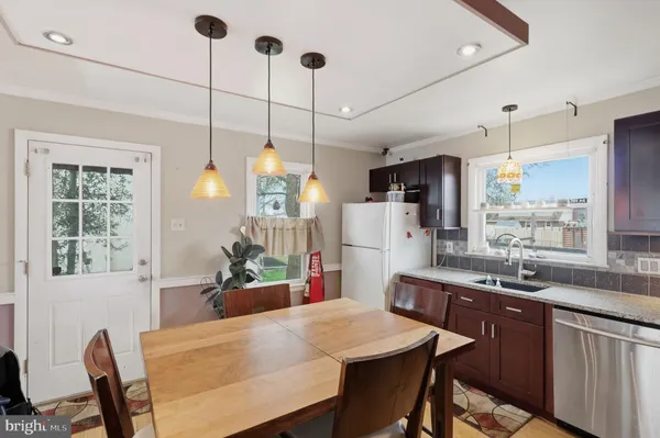 a kitchen with a sink a center island and cabinets