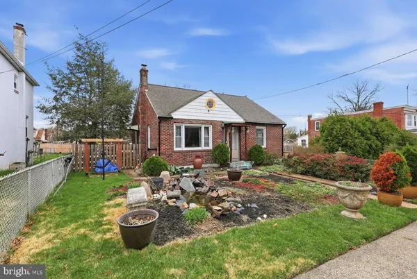 a front view of a house with patio furniture and garden
