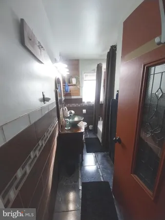 a bathroom with a granite countertop toilet sink and mirror