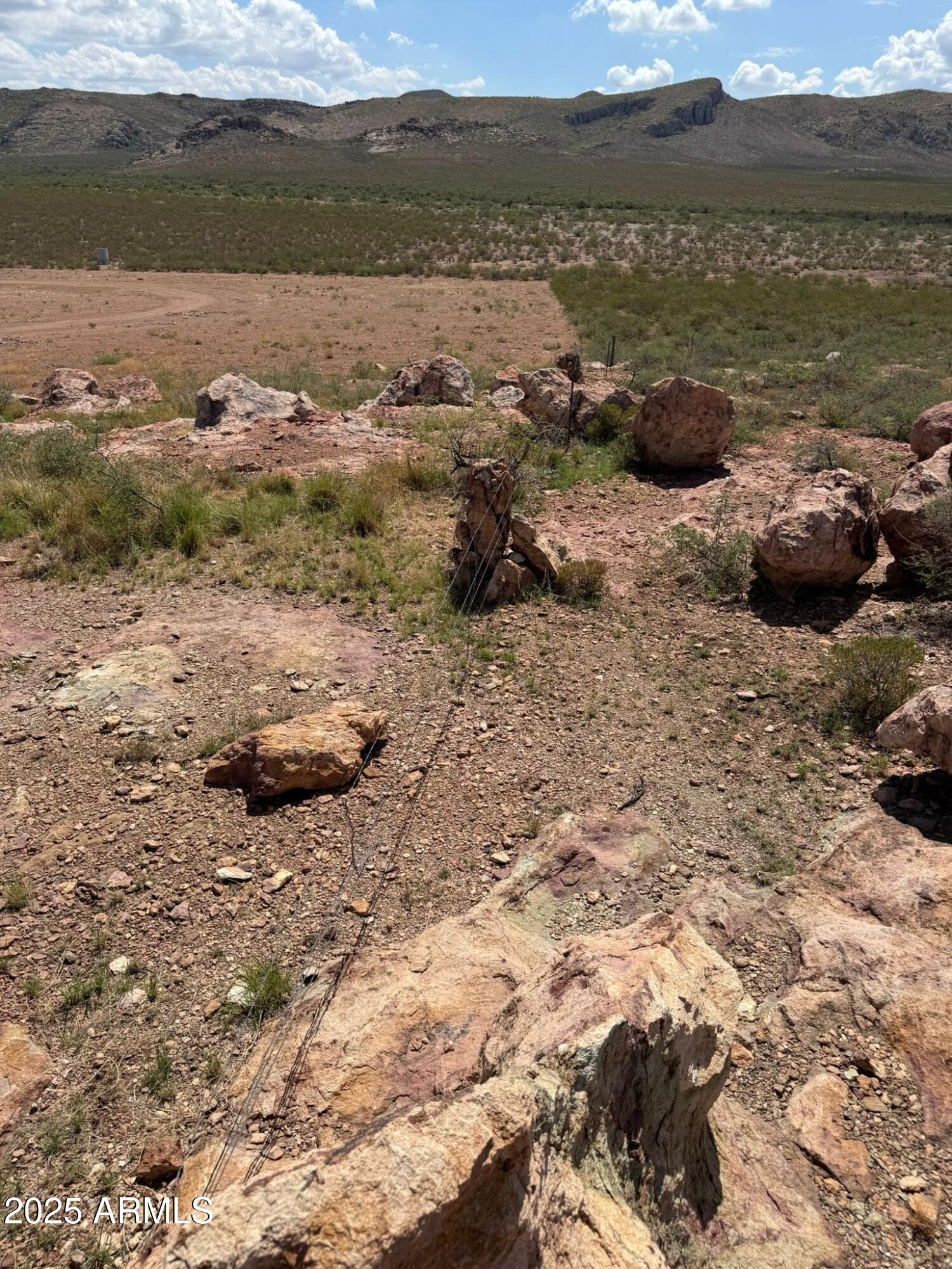 0 East Jack Rabbit Trail, Unit 9 Douglas, AZ 85607 - Photo 5 of 14 a view of a lake with lawn chairs and mountain view