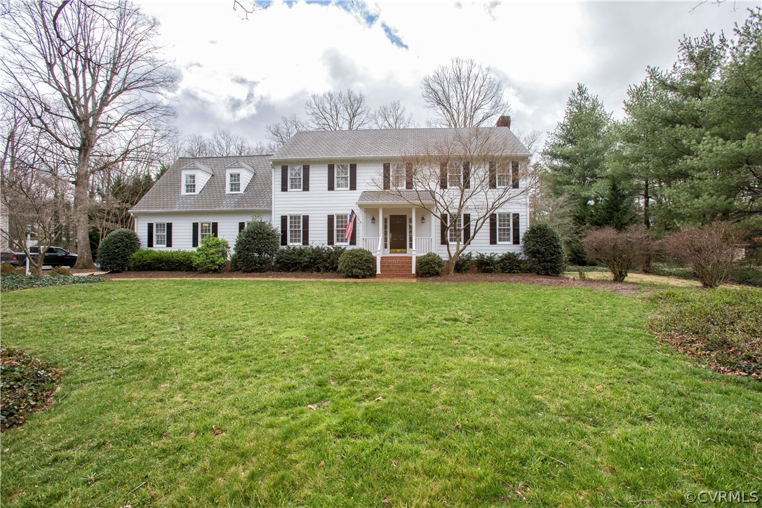 12721 Foxstone Road Midlothian, VA 23113 - Photo 3 of 49 a front view of a house with a garden and trees
