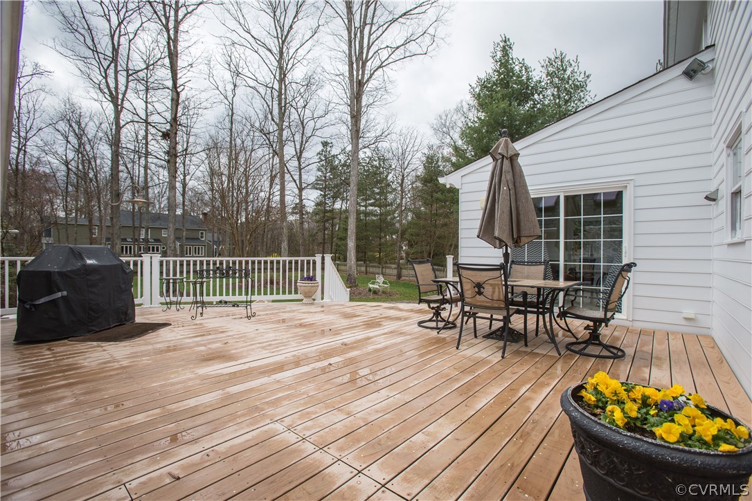 12721 Foxstone Road Midlothian, VA 23113 - Photo 36 of 49 a view of a roof deck with table and chairs and wooden floor