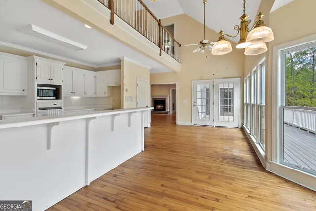a large kitchen with stainless steel appliances granite countertop a lot of counter space and wooden floor