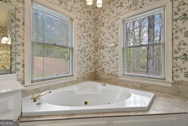 a bathroom with bathtub and window