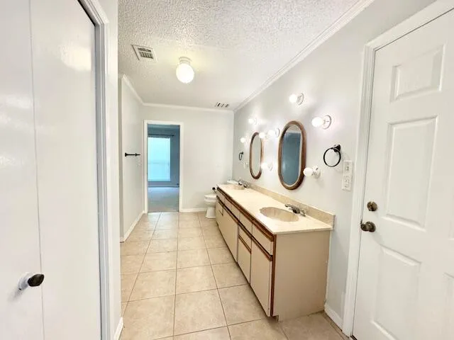 a living room with a mirror and a wooden floor