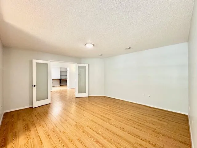 a spacious bathroom with a granite countertop sink mirror and a bath tub