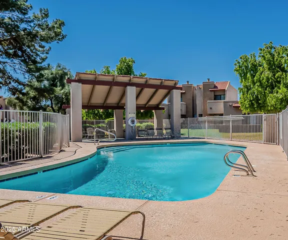 swimming pool view with a seating space