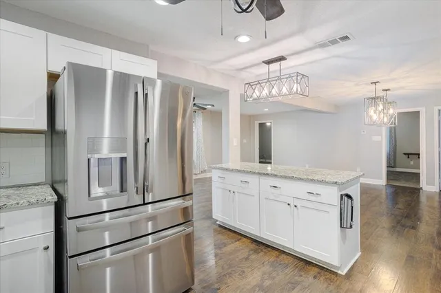 a kitchen with stainless steel appliances a refrigerator and cabinets