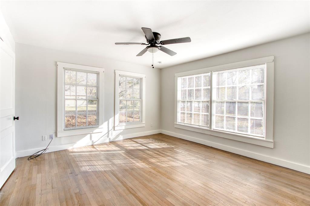 903 West 8th Street Bonham, TX 75418 - Photo 12 of 21 a view of an empty room with a window and wooden floor