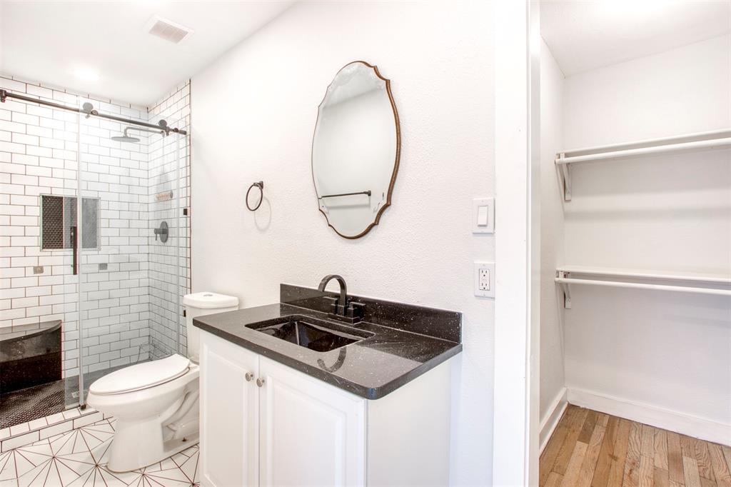 903 West 8th Street Bonham, TX 75418 - Photo 17 of 21 a bathroom with a toilet sink and mirror