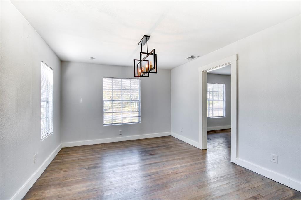 903 West 8th Street Bonham, TX 75418 - Photo 5 of 21 a view of an empty room with wooden floor and a window