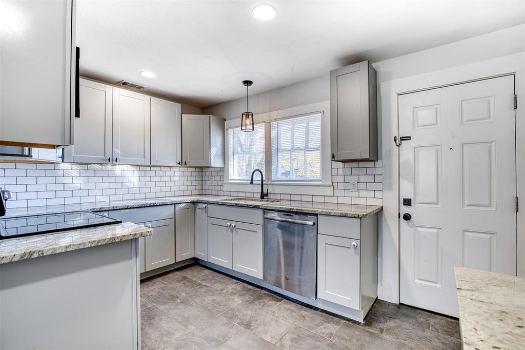 903 West 8th Street Bonham, TX 75418 - Photo 7 of 21 a kitchen with stainless steel appliances granite countertop a sink stove and cabinets