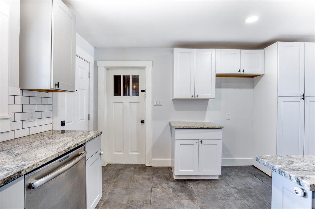 903 West 8th Street Bonham, TX 75418 - Photo 9 of 21 a kitchen with granite countertop a sink and a stove
