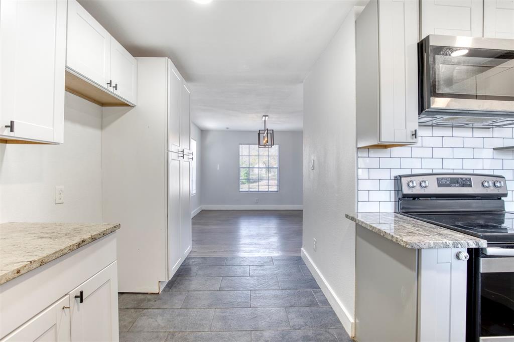 903 West 8th Street Bonham, TX 75418 - Photo 10 of 21 a kitchen with a stove and a sink