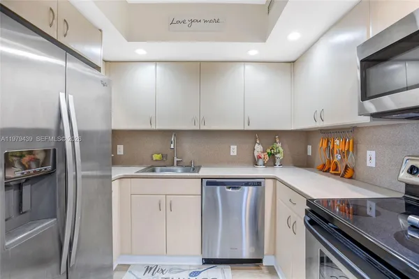 a kitchen with a sink cabinets and stainless steel appliances