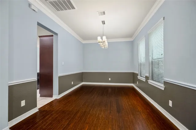wooden floor in a hall with an empty room