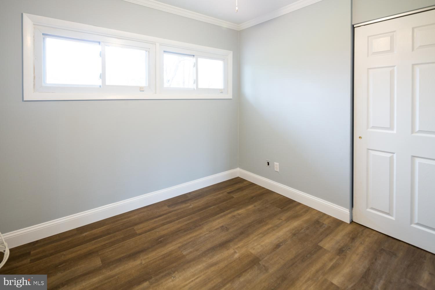 11 Carlisle Road Newark, DE 19713 - Photo 14 of 20 an empty room with wooden floor and windows