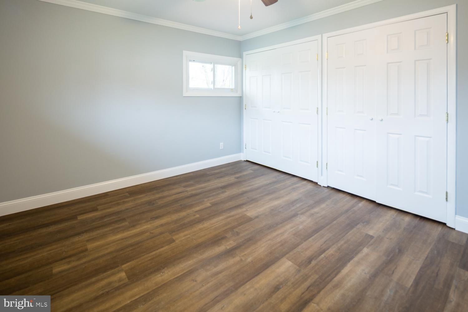 11 Carlisle Road Newark, DE 19713 - Photo 16 of 20 a view of an empty room with wooden floor and a window