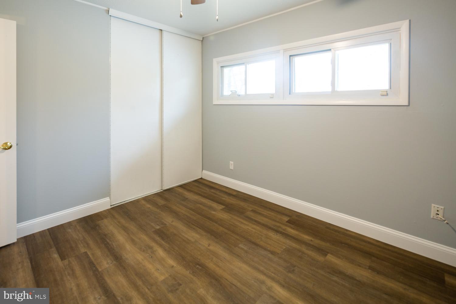 11 Carlisle Road Newark, DE 19713 - Photo 8 of 20 an empty room with wooden floor and windows