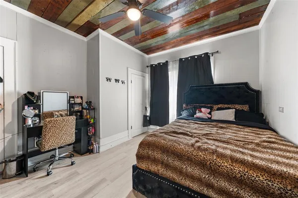 a bedroom with a bed a desk and chair