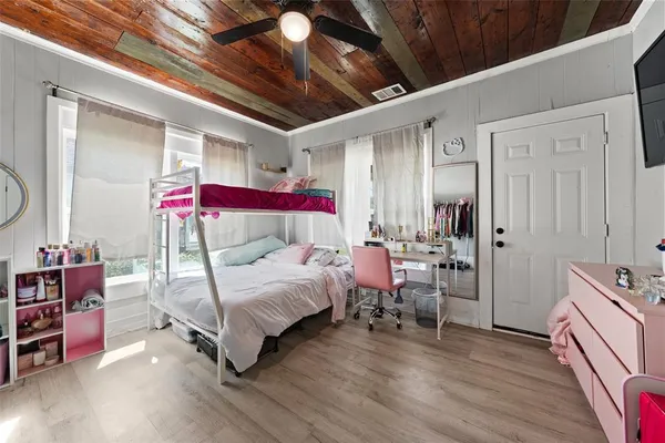 a bedroom with furniture and a wooden floor