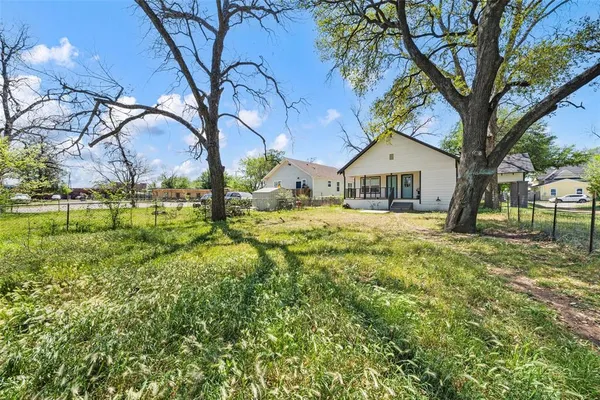 a house with huge green field in front of it