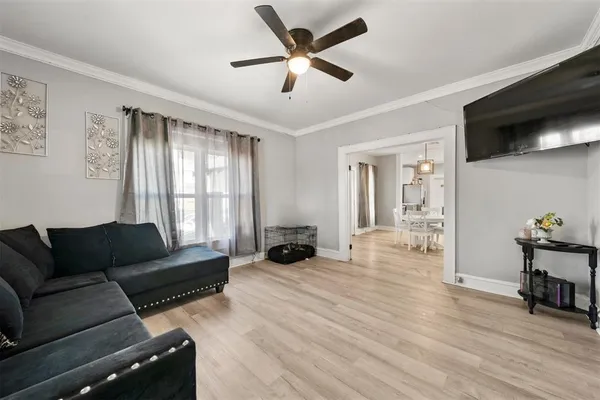 a living room with furniture and a flat screen tv