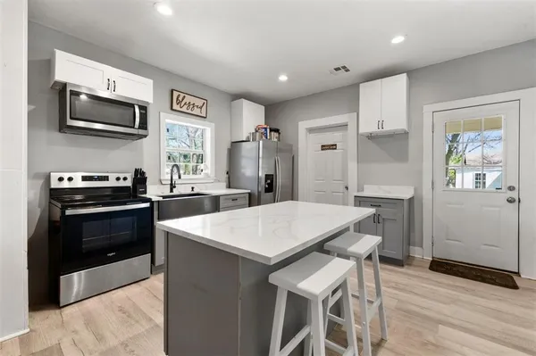 a kitchen with a stove a sink and a refrigerator